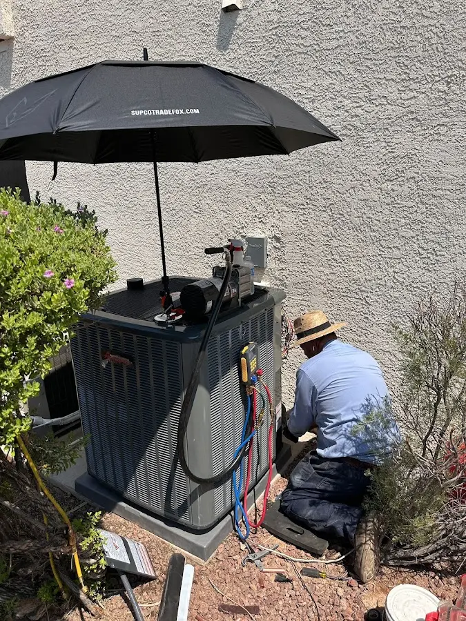 HVAC technician performing outdoor AC maintenance in Parma
